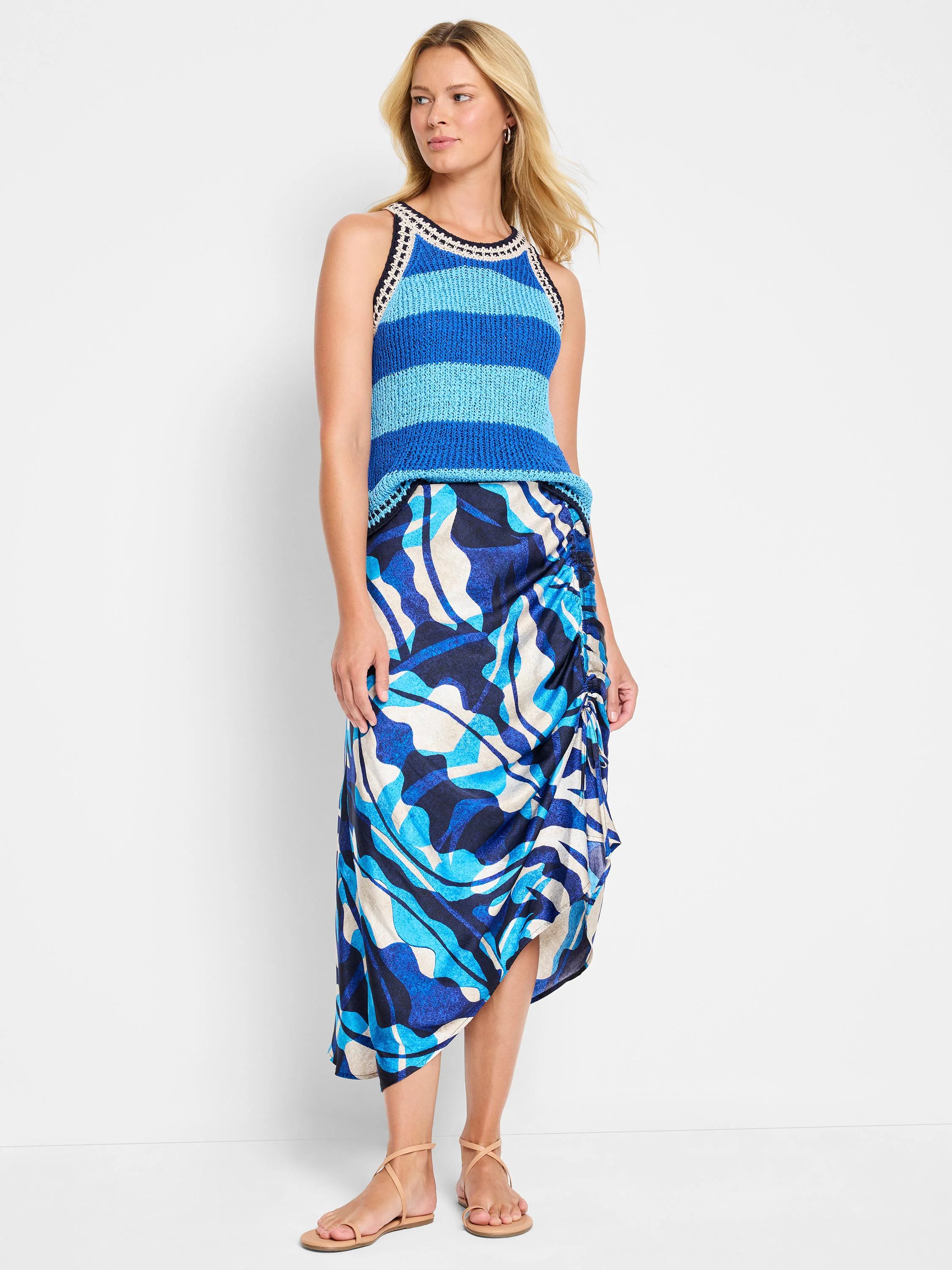 Blue, white, and black abstract print midi skirt with asymmetrical hem and ruching at the side.