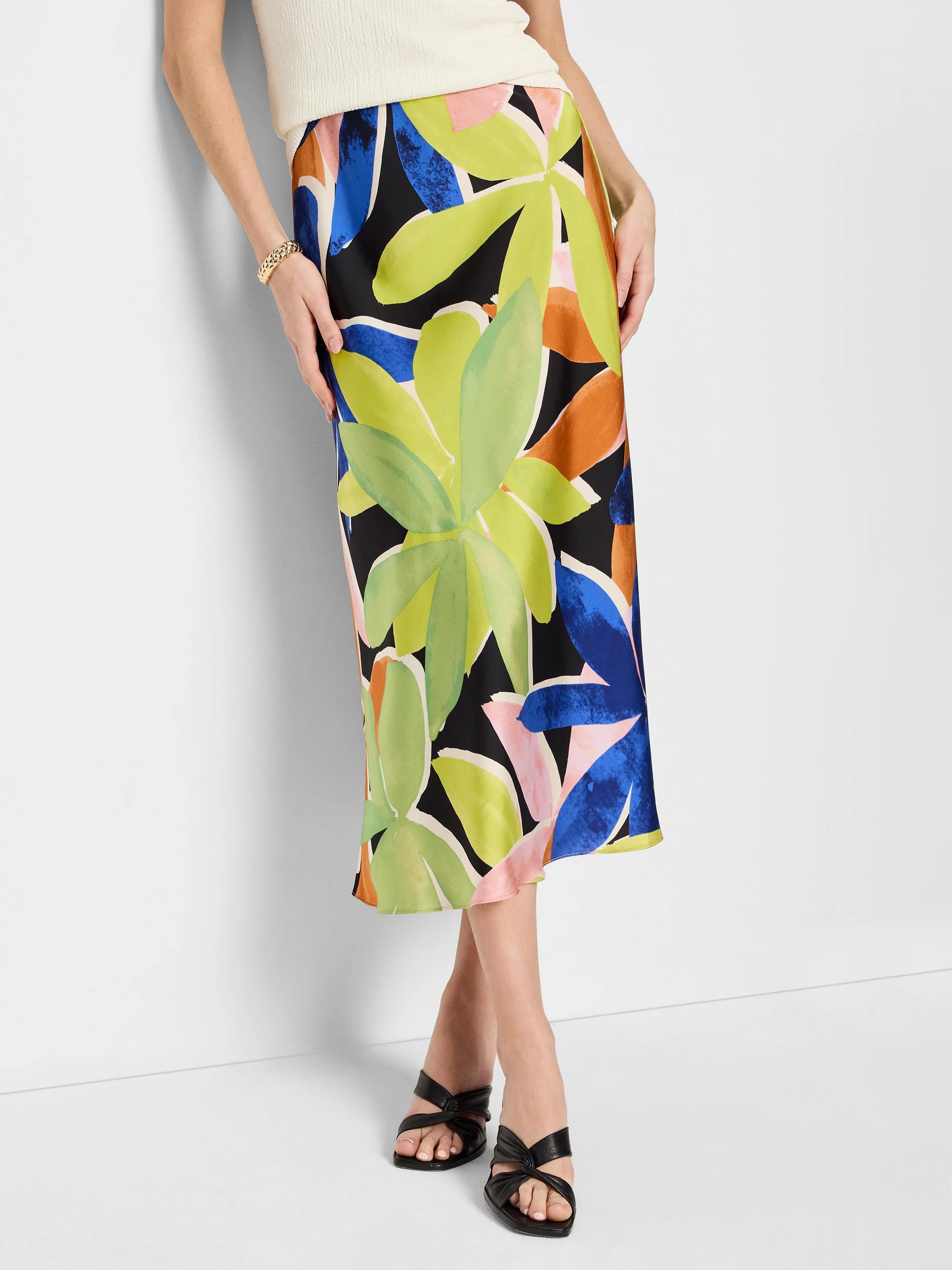 Midi slip skirt, black background, lime green, blue, orange, and pink abstract floral print.