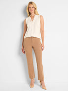 Tan demi boot pants on a model. Smooth fabric, flat front with visible front leg creases.