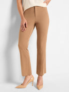 Model wearing tan tailored pants with a flat front, fitted waist, and a slight boot cut at the ankle.