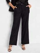 Black wide-leg linen cotton pants; front view shows pockets and mid-rise waist.