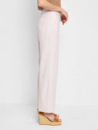 Off-white linen-cotton wide-leg pants shown on a model.  Side view.