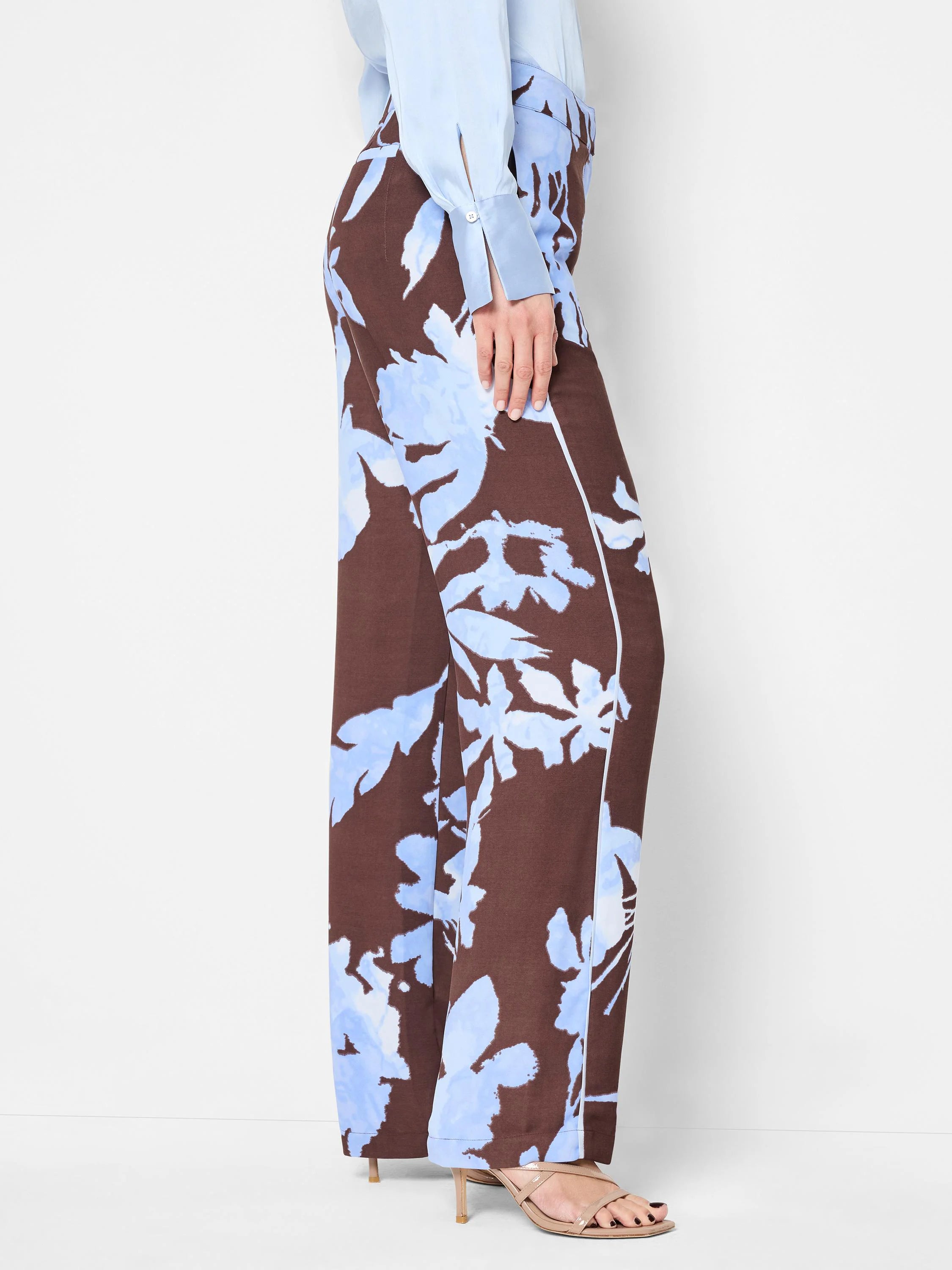 Brown wide-leg pants with a light blue floral print and subtle side stripe.