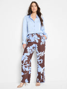 Brown wide-leg pants with a light blue floral print.