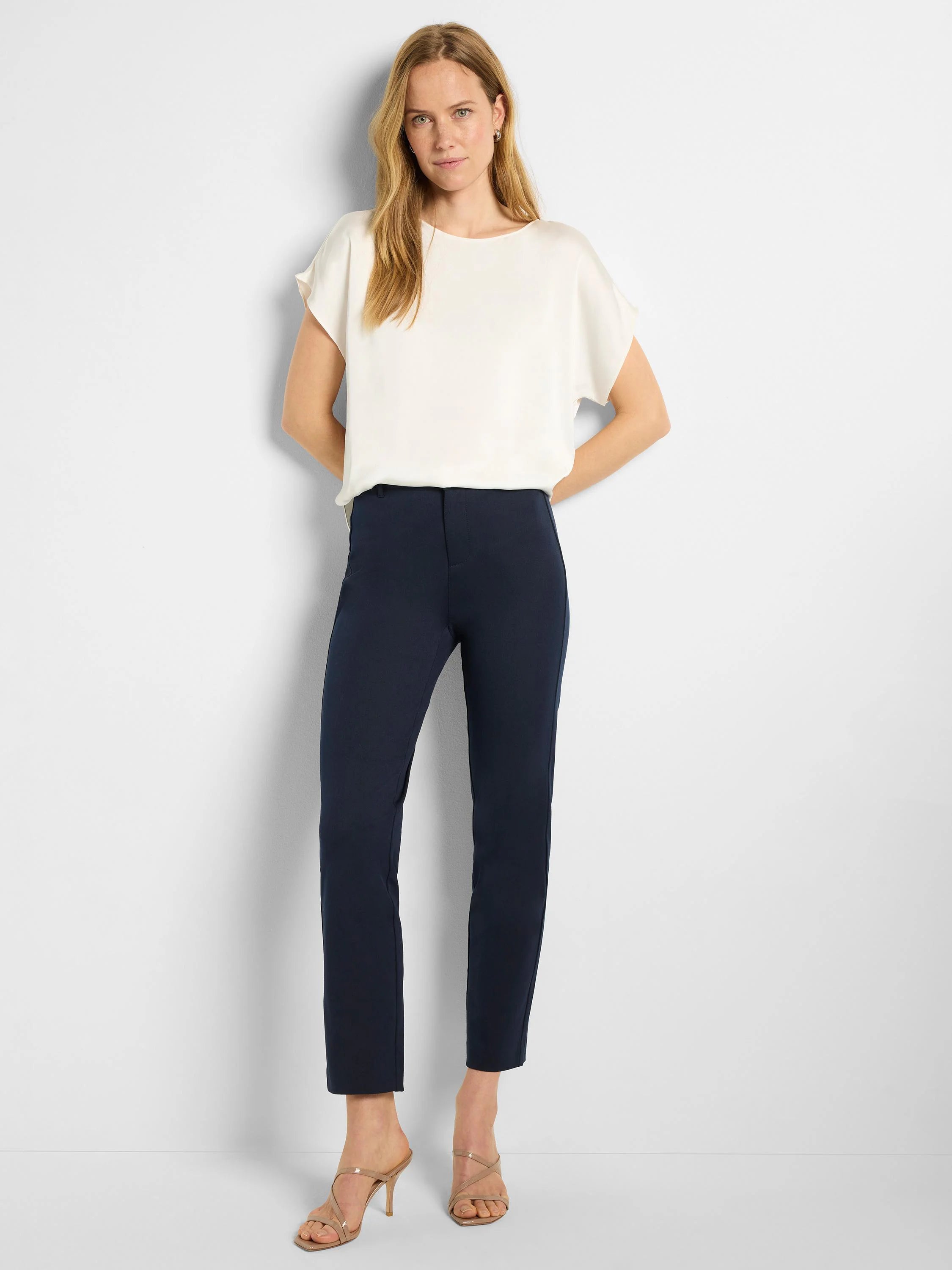 Dark navy straight-leg pants with a flat front and ankle-length hem. Worn by a model.