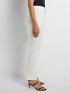 Side view of cream, fitted straight-leg pants with a flat waistband.