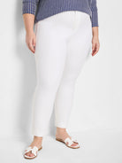 White straight-leg pants with a visible front zipper fly, ending at the ankle. Smooth fabric texture.