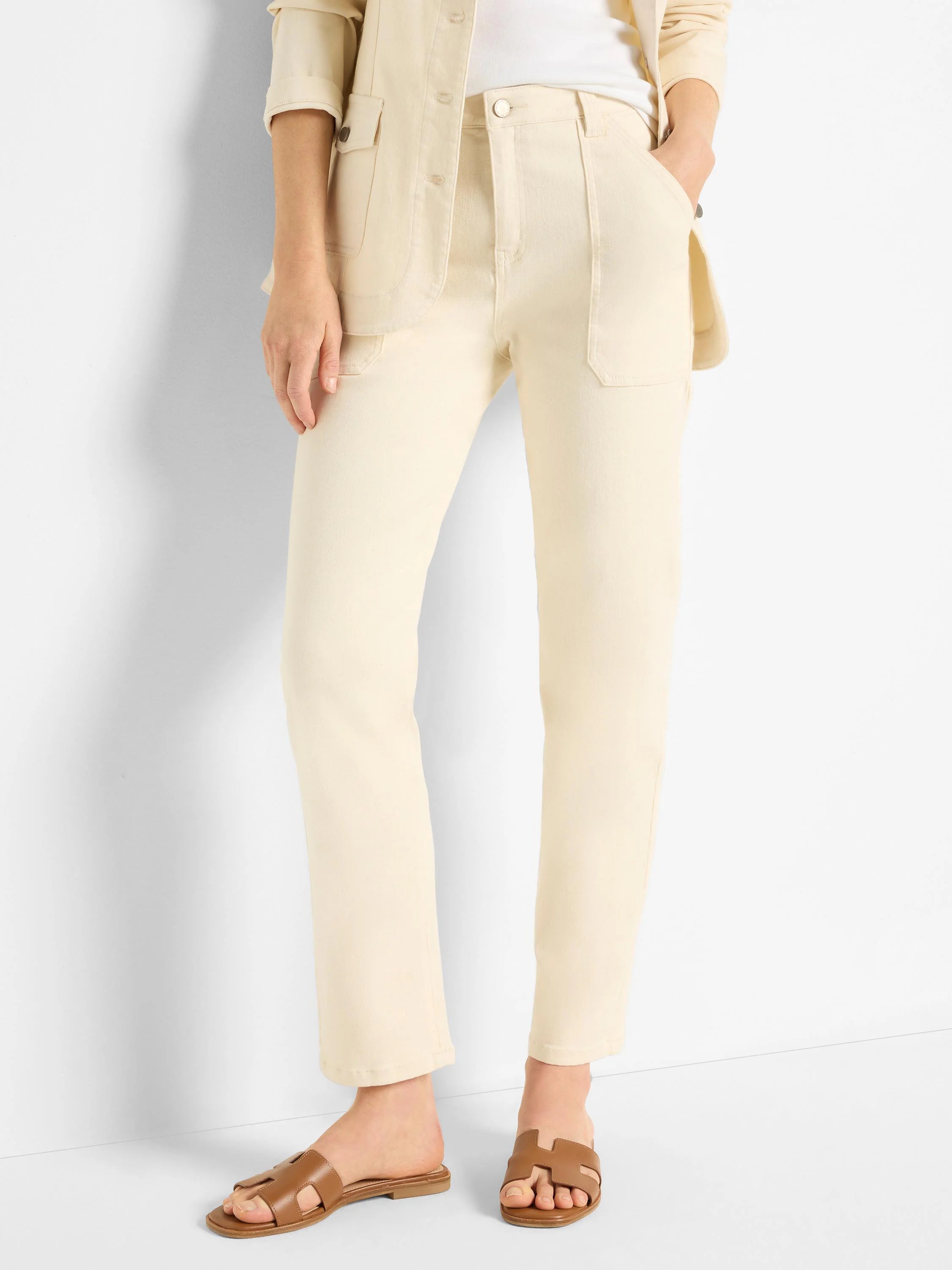 Off-white straight-leg jeans; model wears brown sandals.