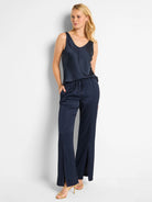 Navy blue satin pants with front slits and drawstring waist.