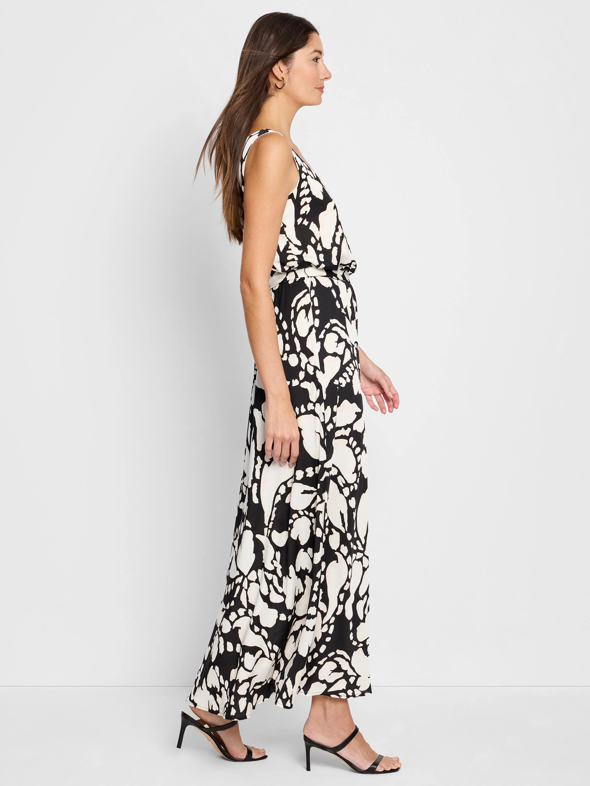 Black maxi dress with off-white abstract floral print. Sleeveless, V-neck.