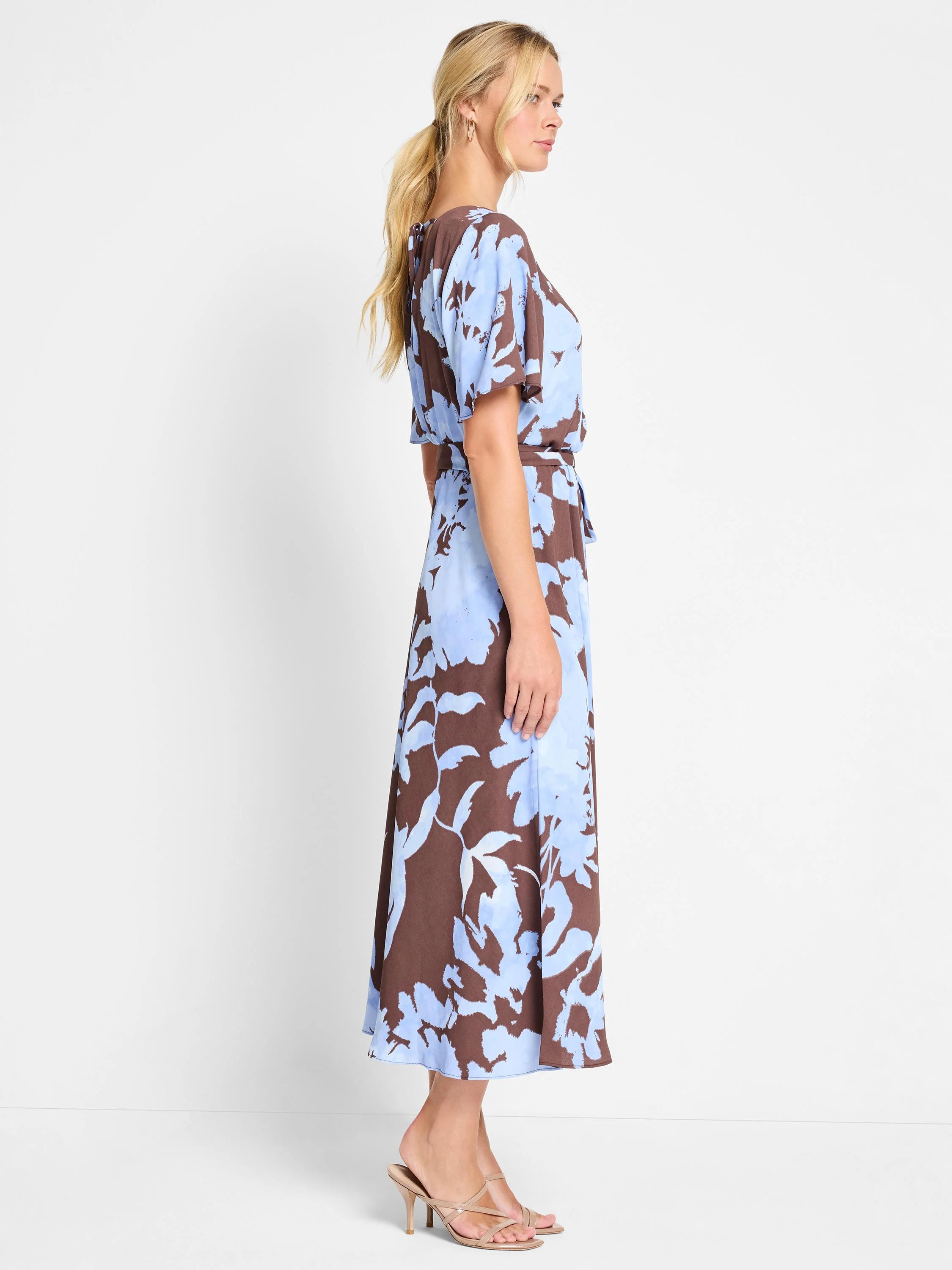 Brown midi dress with light blue abstract floral print, short sleeves, and a self-tie belt.