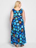 Black sleeveless maxi dress with an abstract print in blues, teals, and browns.  V-neck.