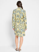 Yellow shirt dress with blue and white abstract print, collared, long sleeves, belted waist, knee-length.