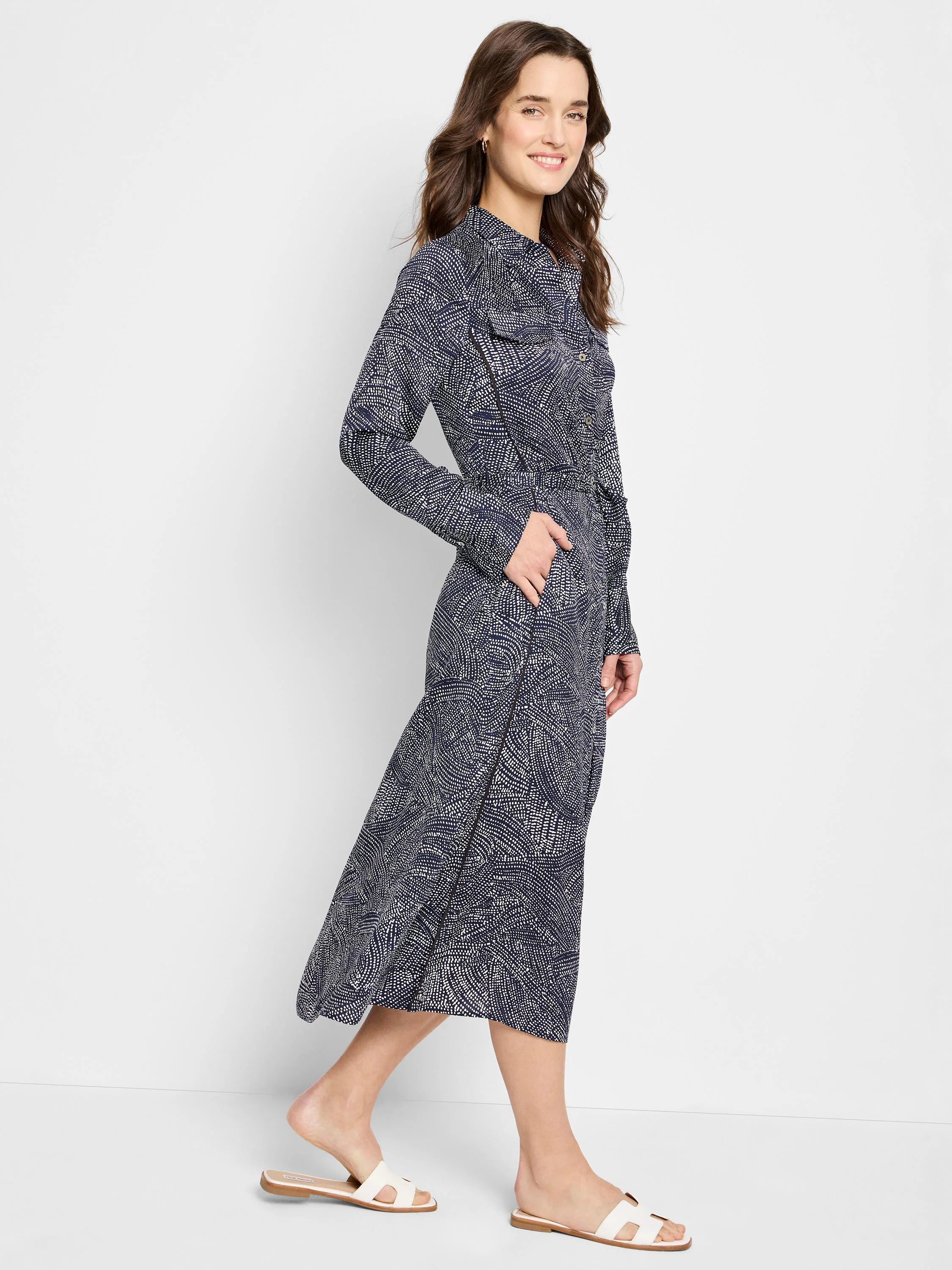 Navy midi shirt dress with a white swirling pattern.  Long sleeves, belted waist.