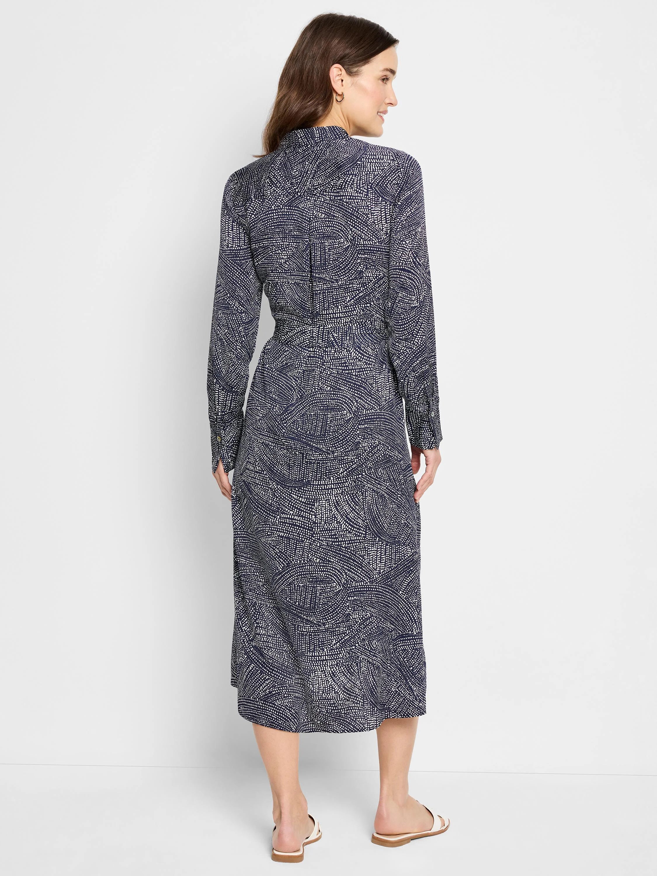 Navy midi shirt dress with a white swirling pattern.  Long sleeves, collared neckline.