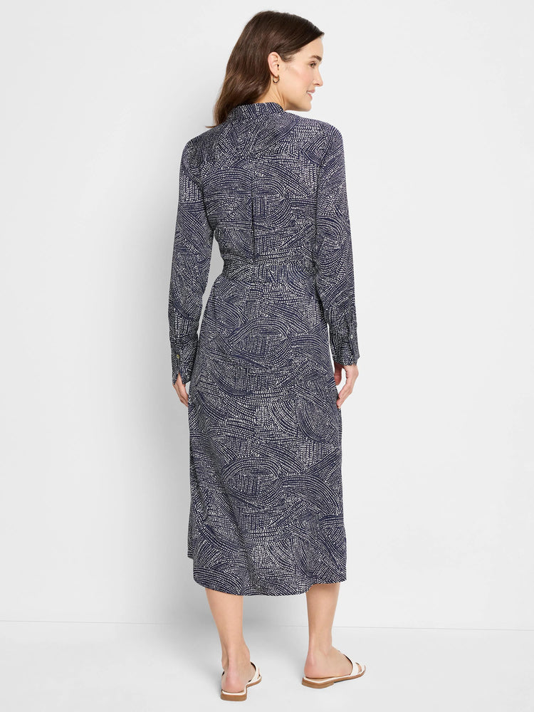 Navy midi shirt dress with a white swirling pattern. Long sleeves, collared neckline.