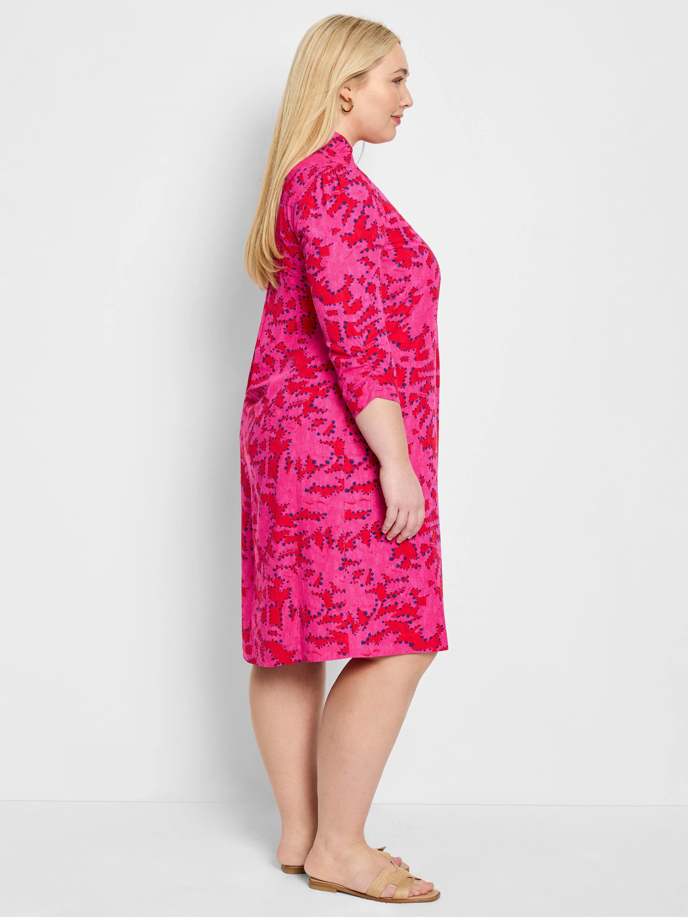 Pink knee-length dress with red & blue abstract print, 3/4 sleeves, ruffled detail.