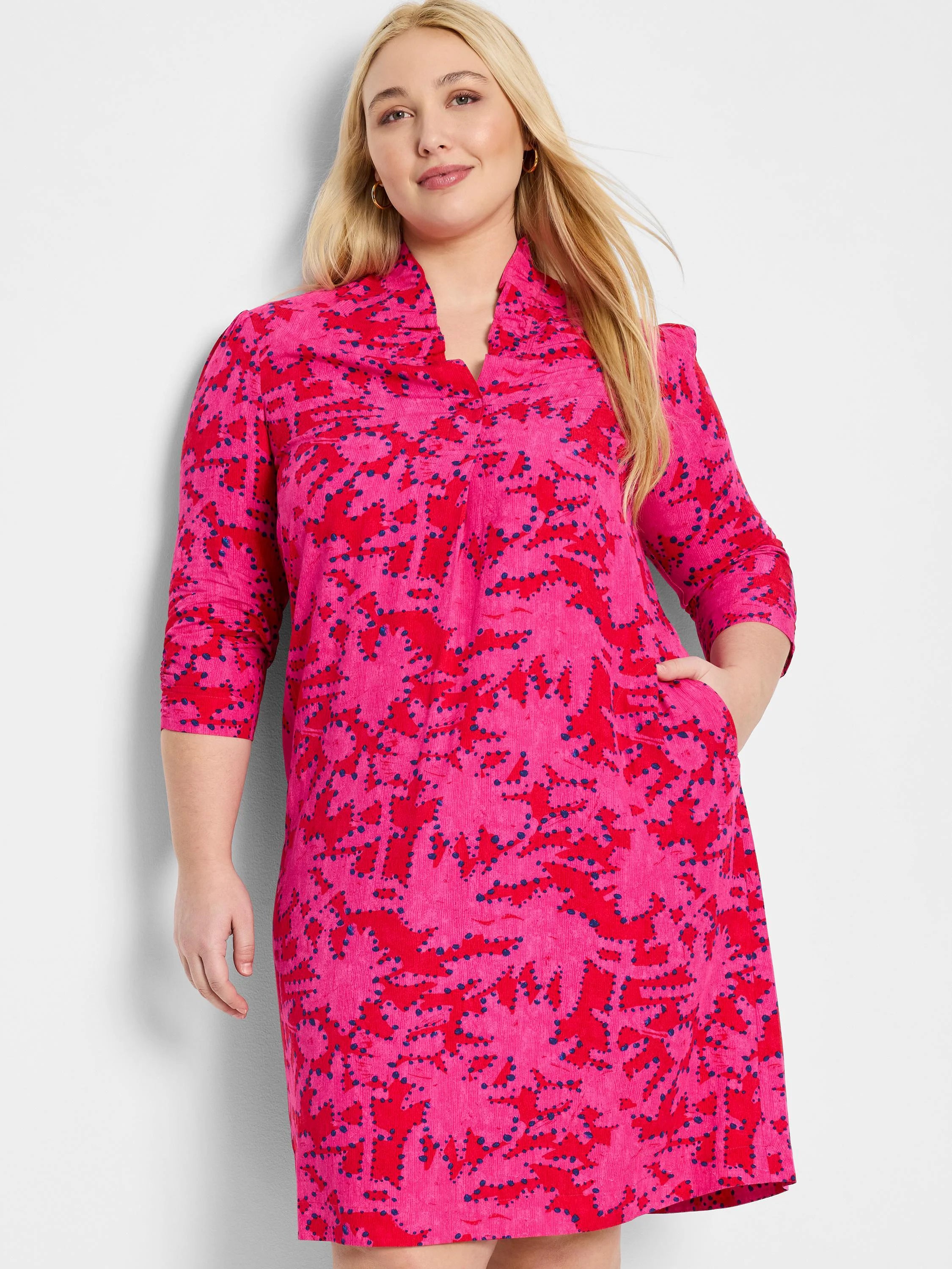 Pink dress with red and dark blue abstract print, 3/4 sleeves, and pockets.