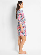 Here's alt text for the image, under 125 characters:
"Side view of a knee-length shirt dress with an abstract pink,...