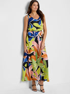Maxi dress, sleeveless, V-neck.  Black background with large lime, pink, orange, and blue leaf print.  Belted waist.