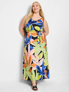 Maxi dress, sleeveless, V-neck.  Black background with large abstract floral print in blue, pink, orange, & lime green. ...