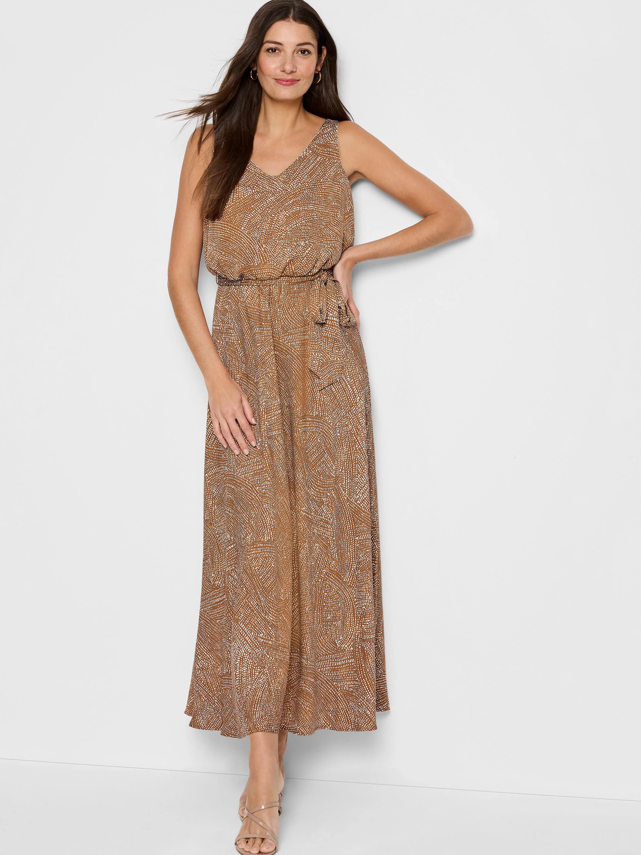 Brown maxi dress with a white abstract print, sleeveless, V-neck, and a self-tie belt.