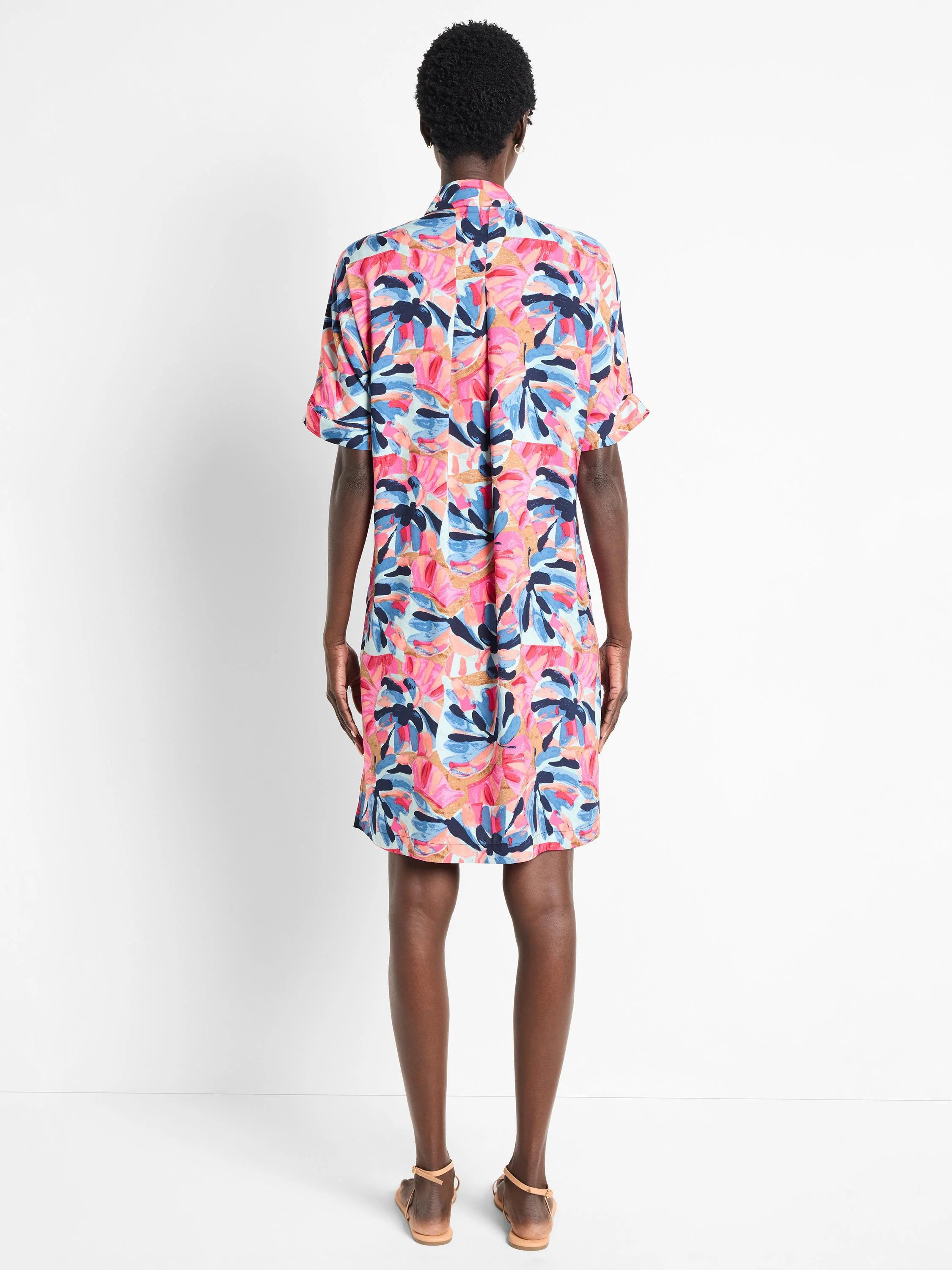 Short, collared shirt dress; pink, blue, and tan abstract floral print.  Short sleeves.