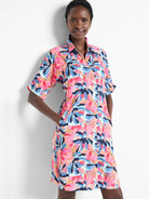 Short-sleeved collared dress in pink, blue, tan, and navy abstract floral print.  Features pockets.