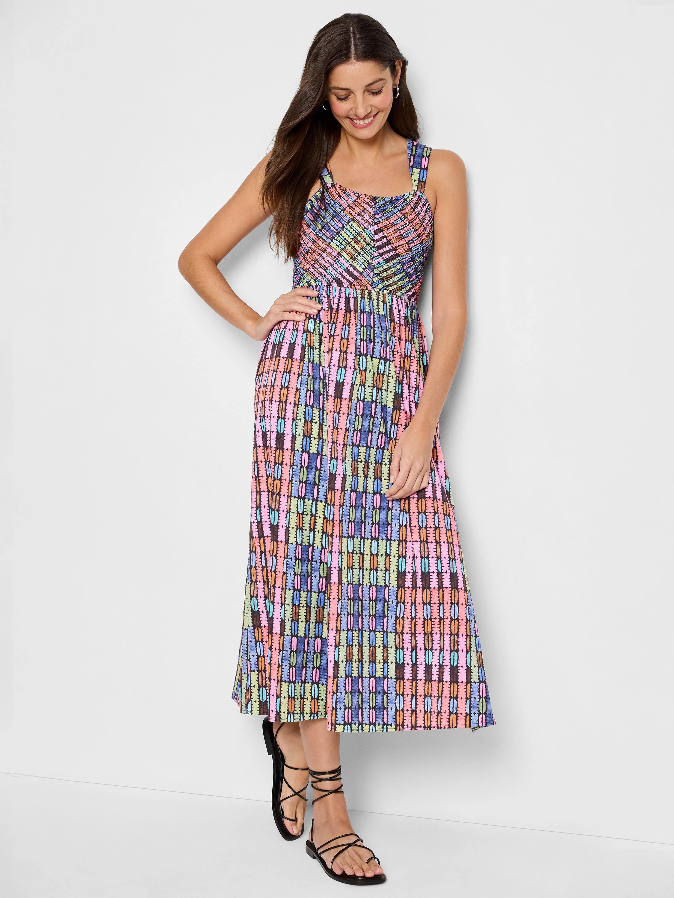 Midi dress, sleeveless, with a multicolored geometric pattern on a dark background.  Pink, light blue, green, and brown...