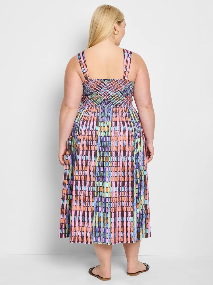 Midi dress, sleeveless, dark background with vertical stripes of pink, orange, teal, and light green. Geometric pattern.