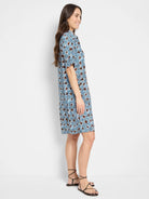 Blue and brown patterned knee-length dress, short sleeves, collared neckline.