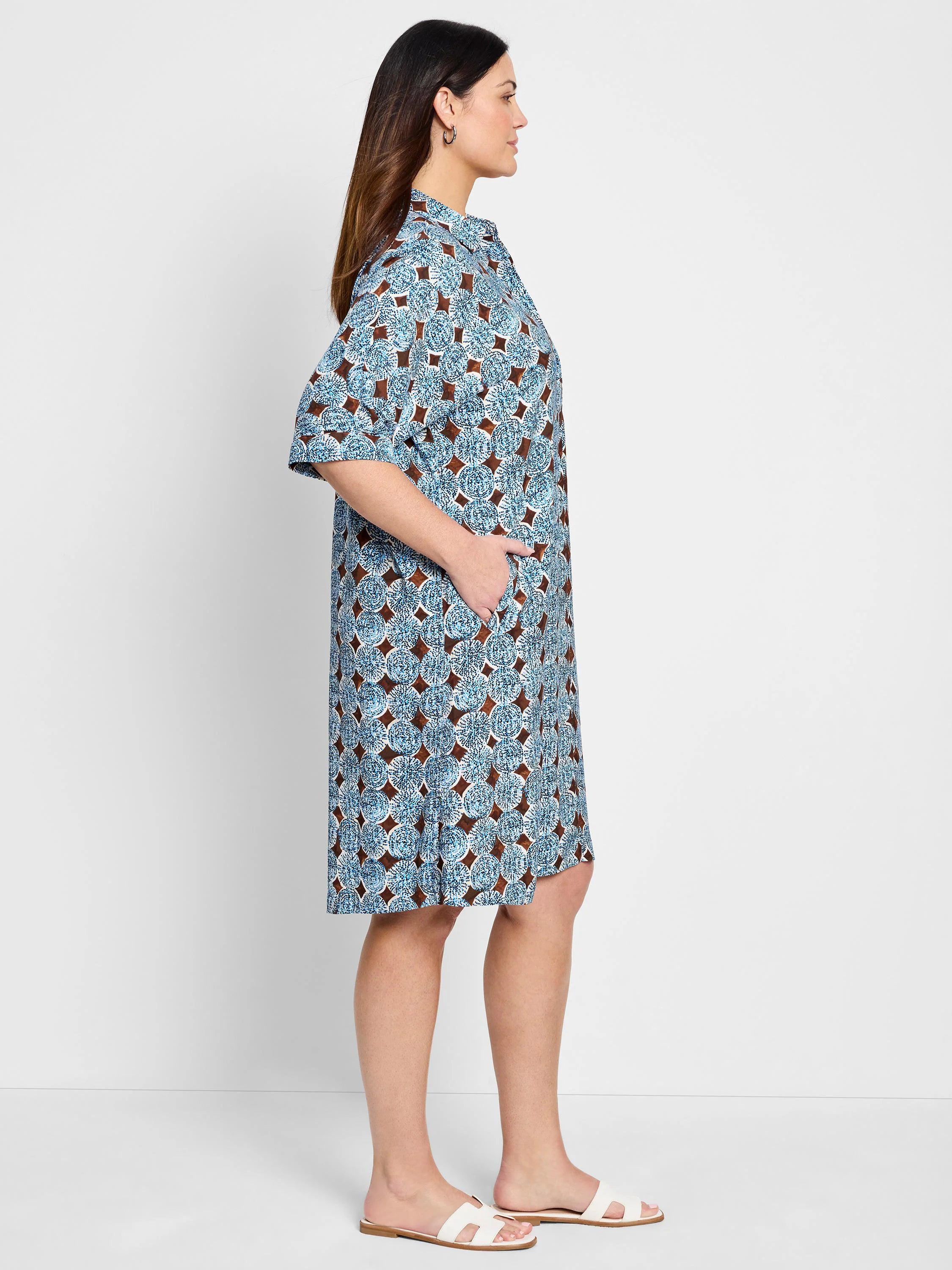 Blue and brown patterned shirt dress, short sleeves, knee length, model shown wearing white sandals.