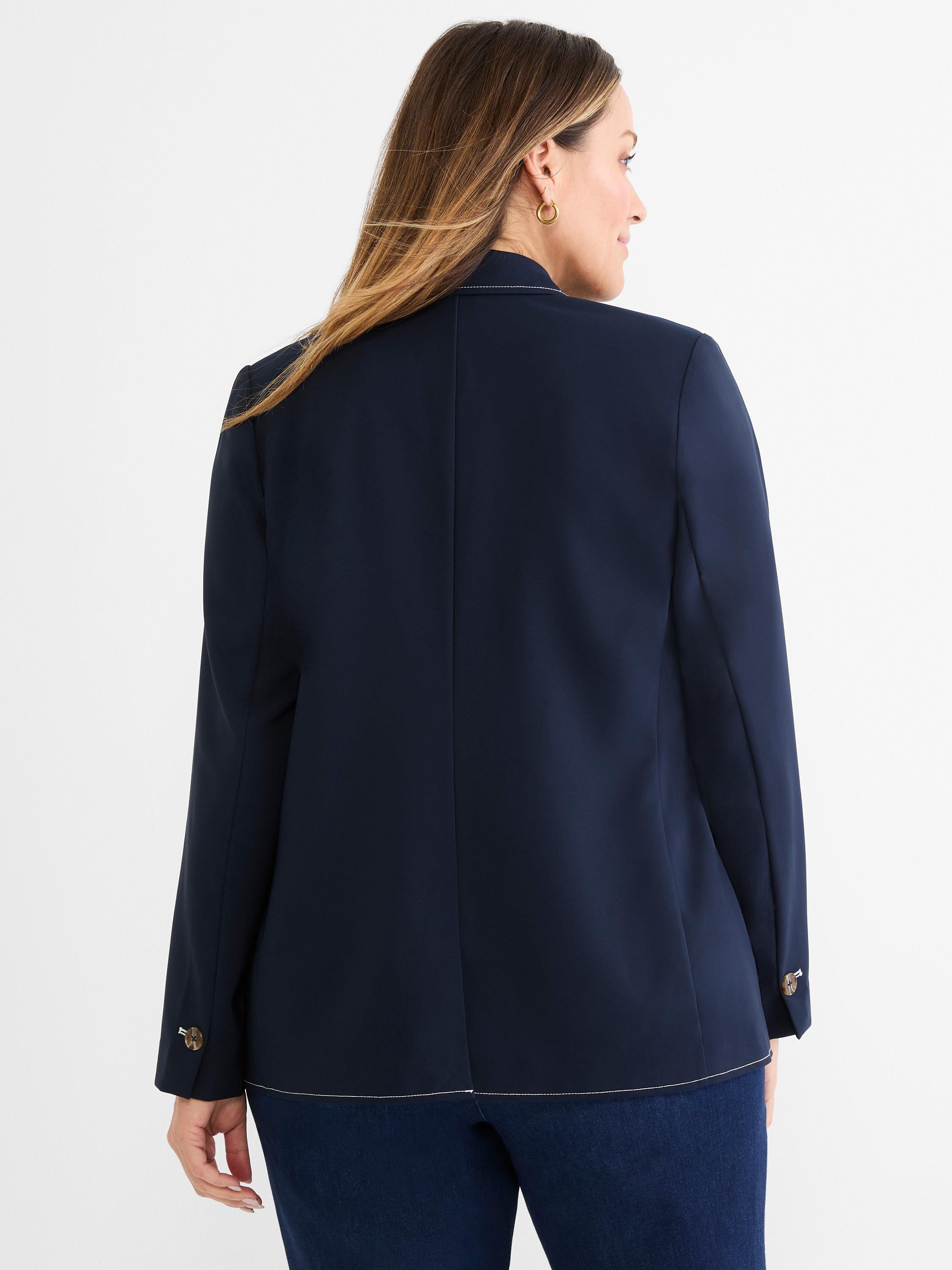 This dark navy tailored blazer has contrast white topstitching along the hem and cuffs with decorative buttons.