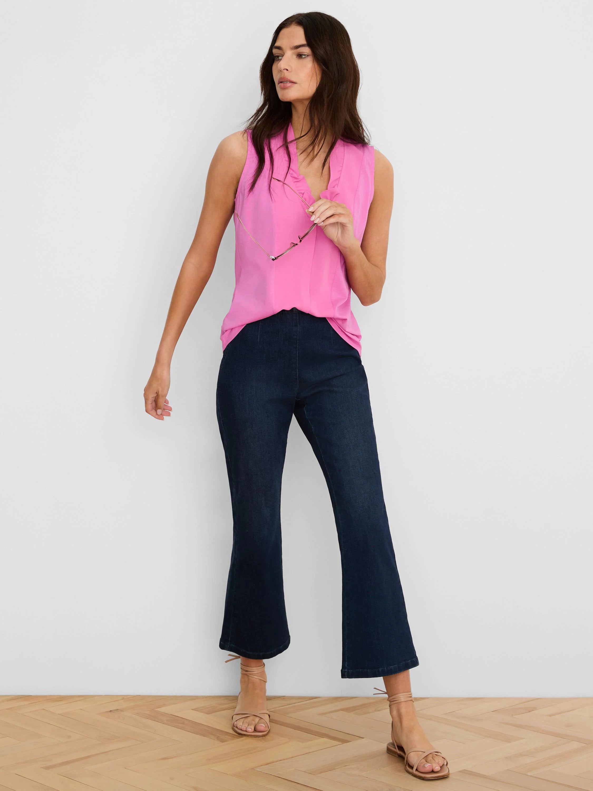 Pink sleeveless tank with a ruffled V-neck.