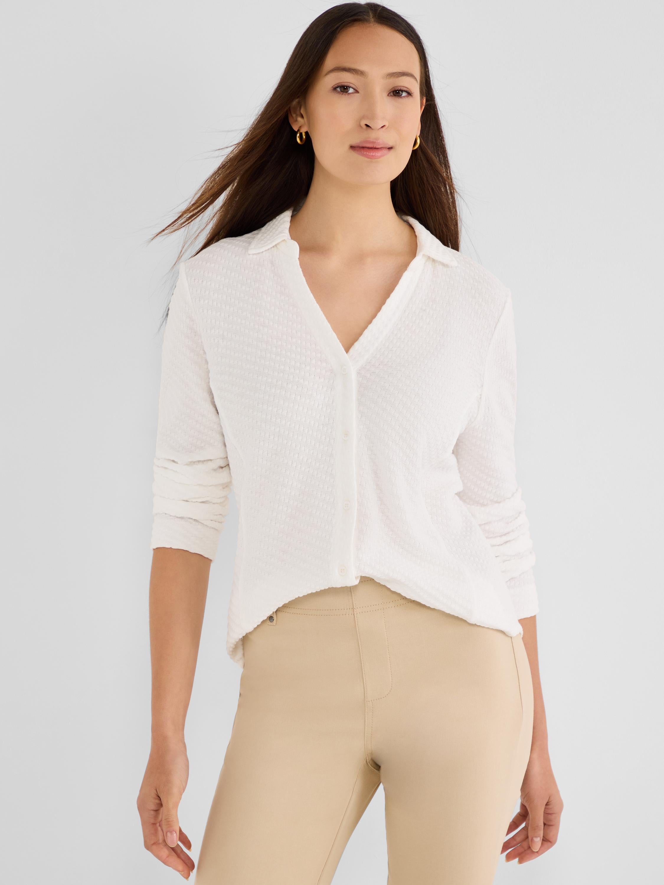 A relaxed off-white button-front shirt in a subtle textured knit, featuring a soft polo collar and long sleeves.