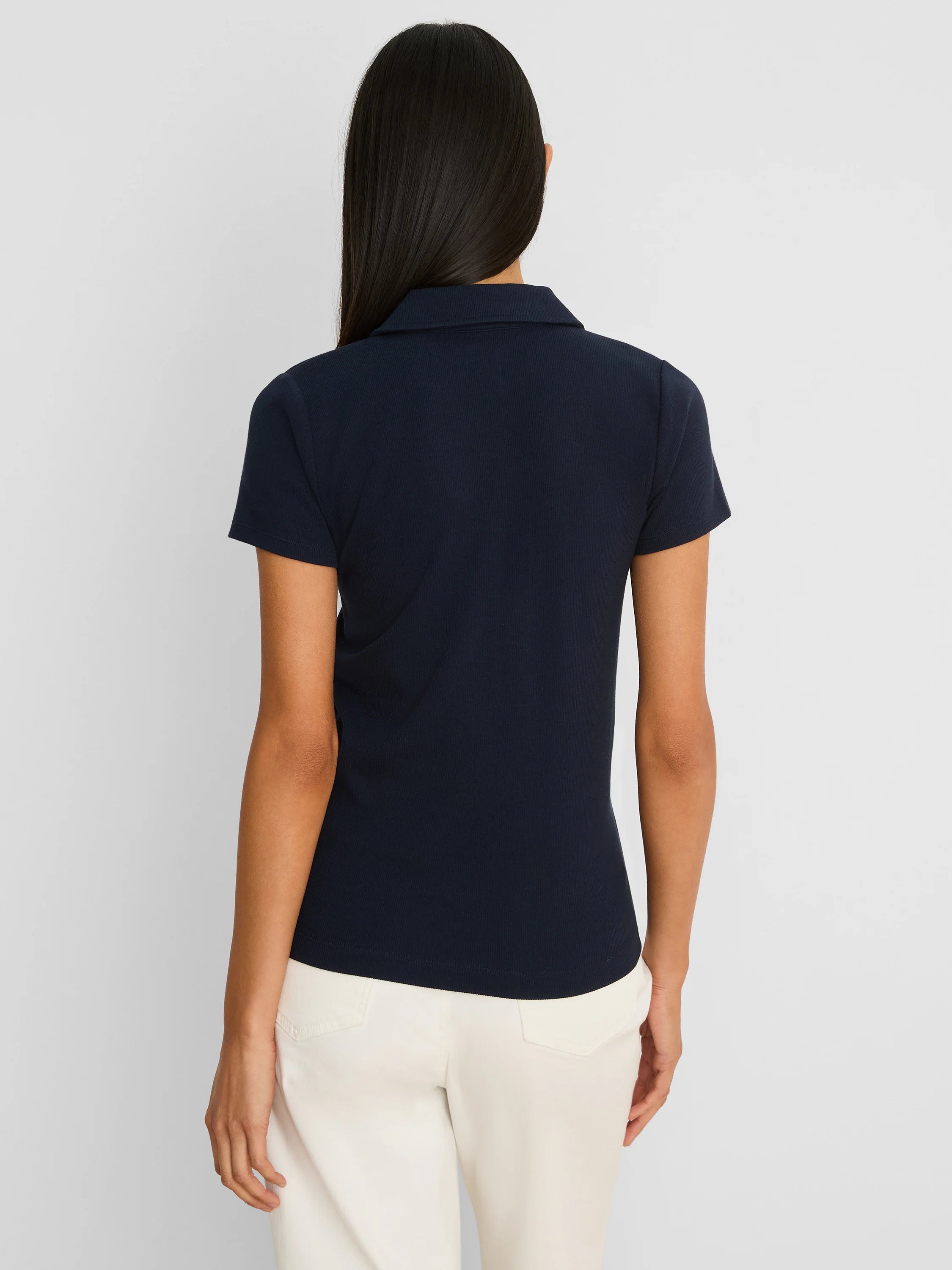Dark navy, ribbed short sleeve polo. Fitted and shown from behind.