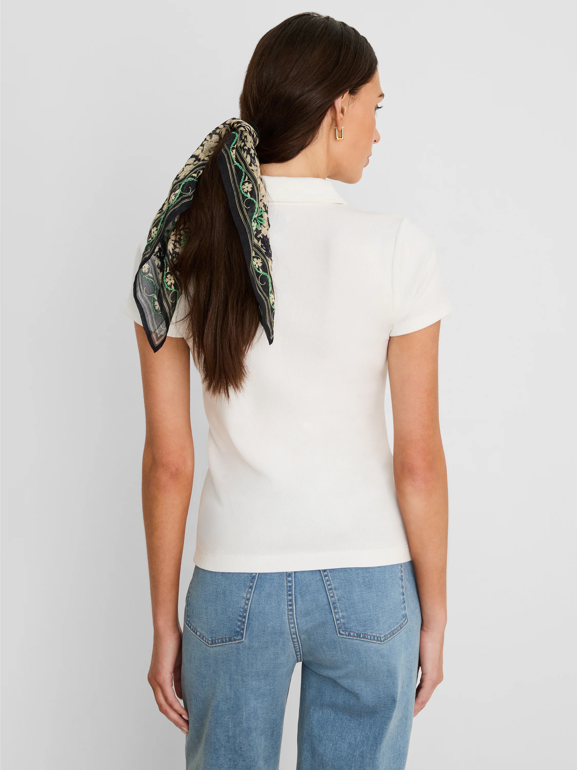 Cream knit ribbed short-sleeve polo shirt, shown from the back on a model.