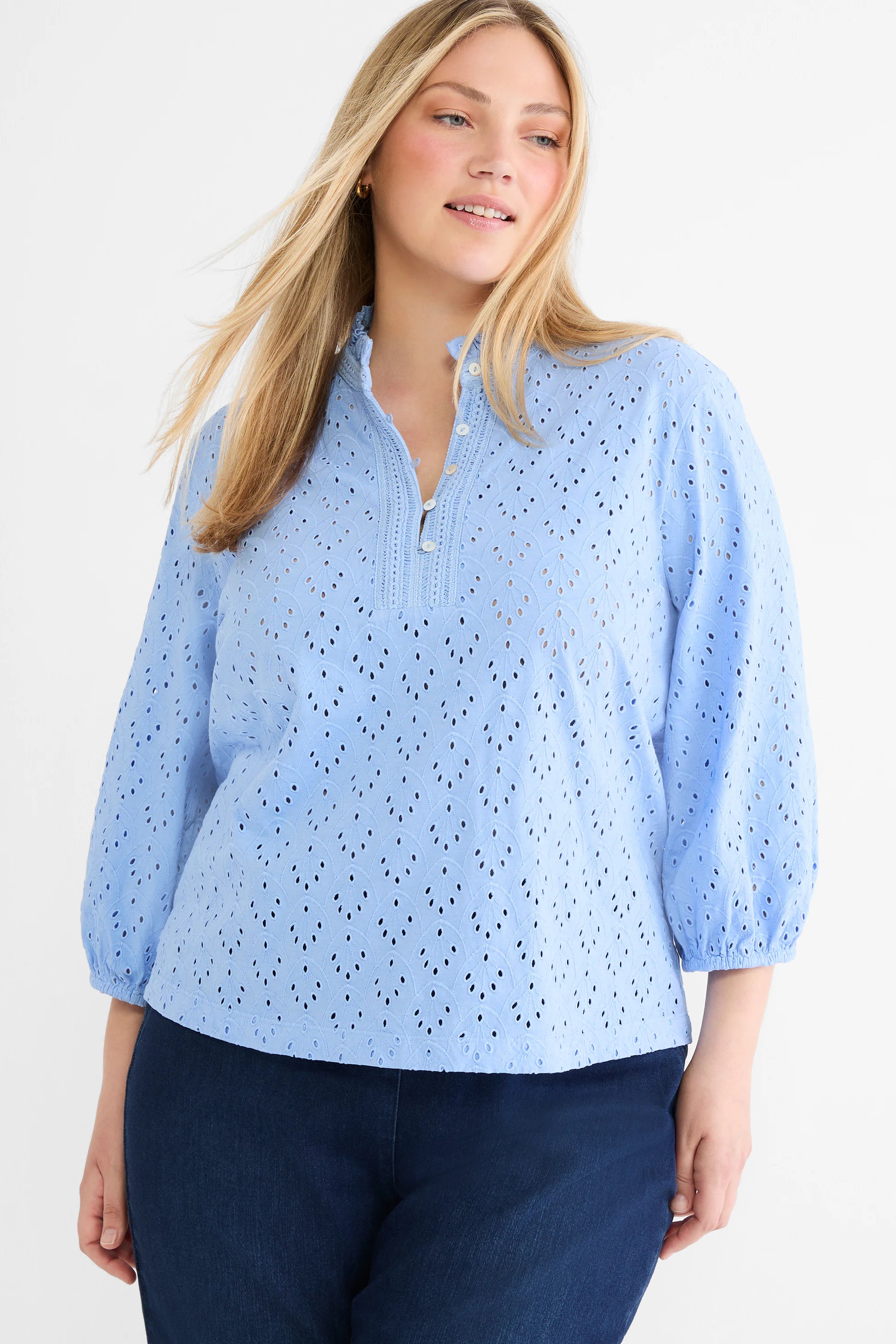 Light blue eyelet top with leaf pattern, ruffled stand collar, partial button placket, and 3/4 puff sleeves.