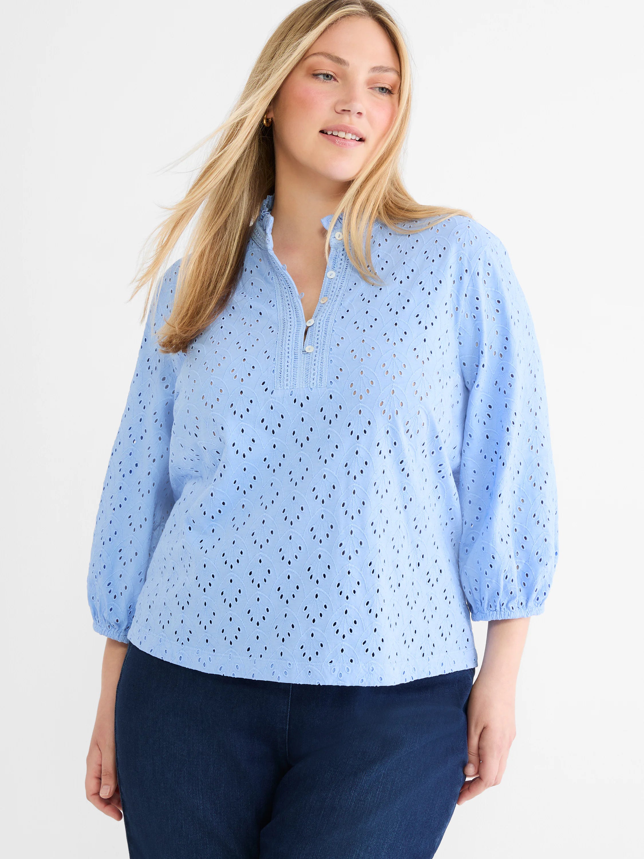 Light blue eyelet top with leaf pattern, ruffled stand collar, partial button placket, and 3/4 puff sleeves.