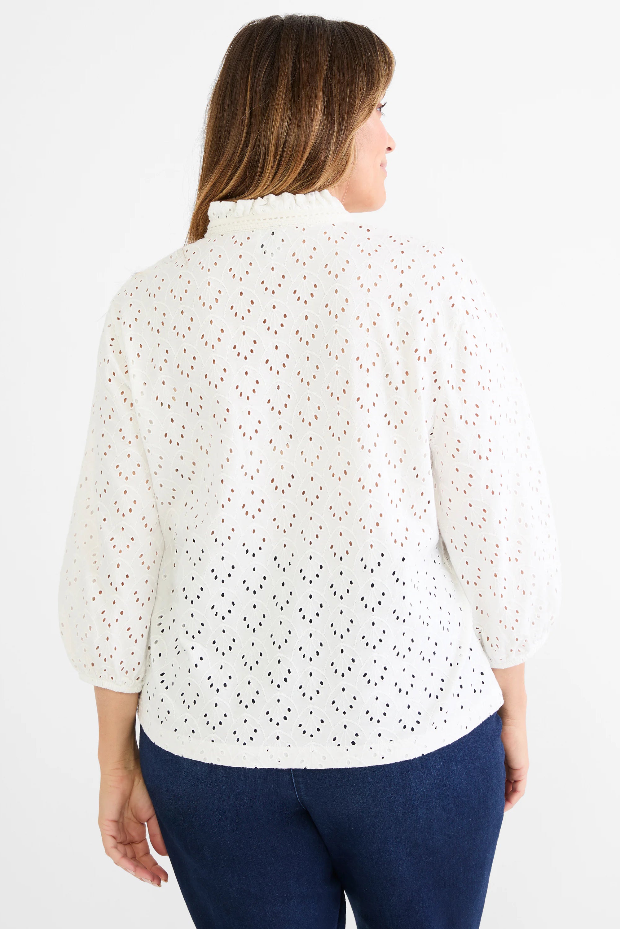 White eyelet top with a ruffle neck and puffy 3/4 sleeves.