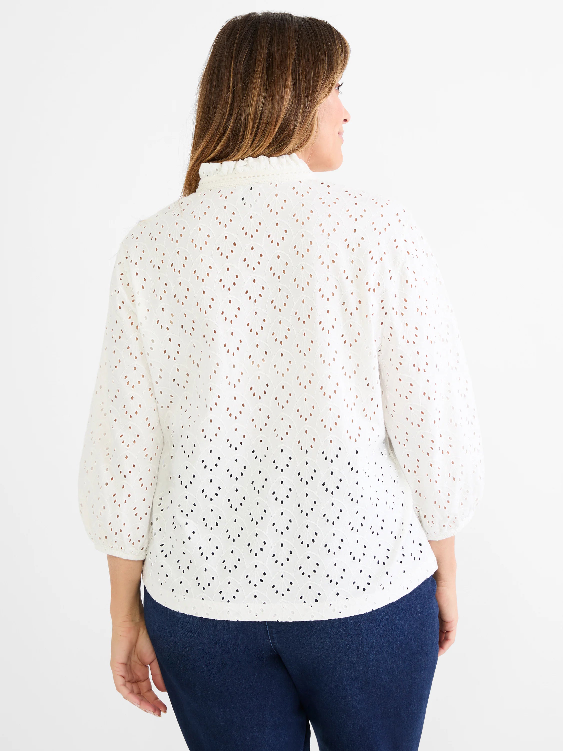 White eyelet top with a ruffle neck and puffy 3/4 sleeves.