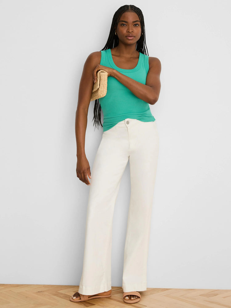 Model wears a teal ribbed knit scoop tank top.