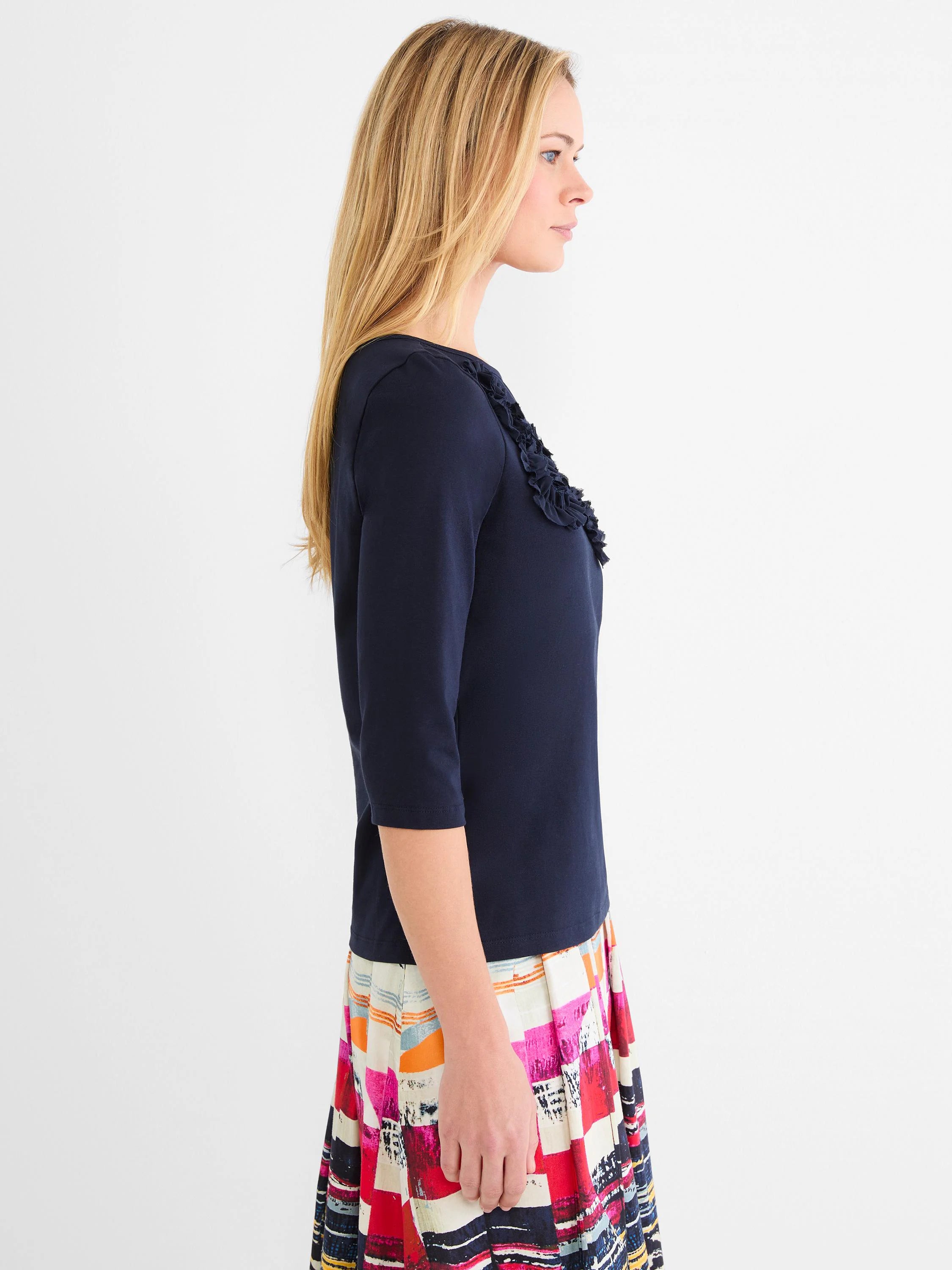 Navy blue 3/4 sleeve top with ruffled mesh applique detail on the right shoulder and chest.