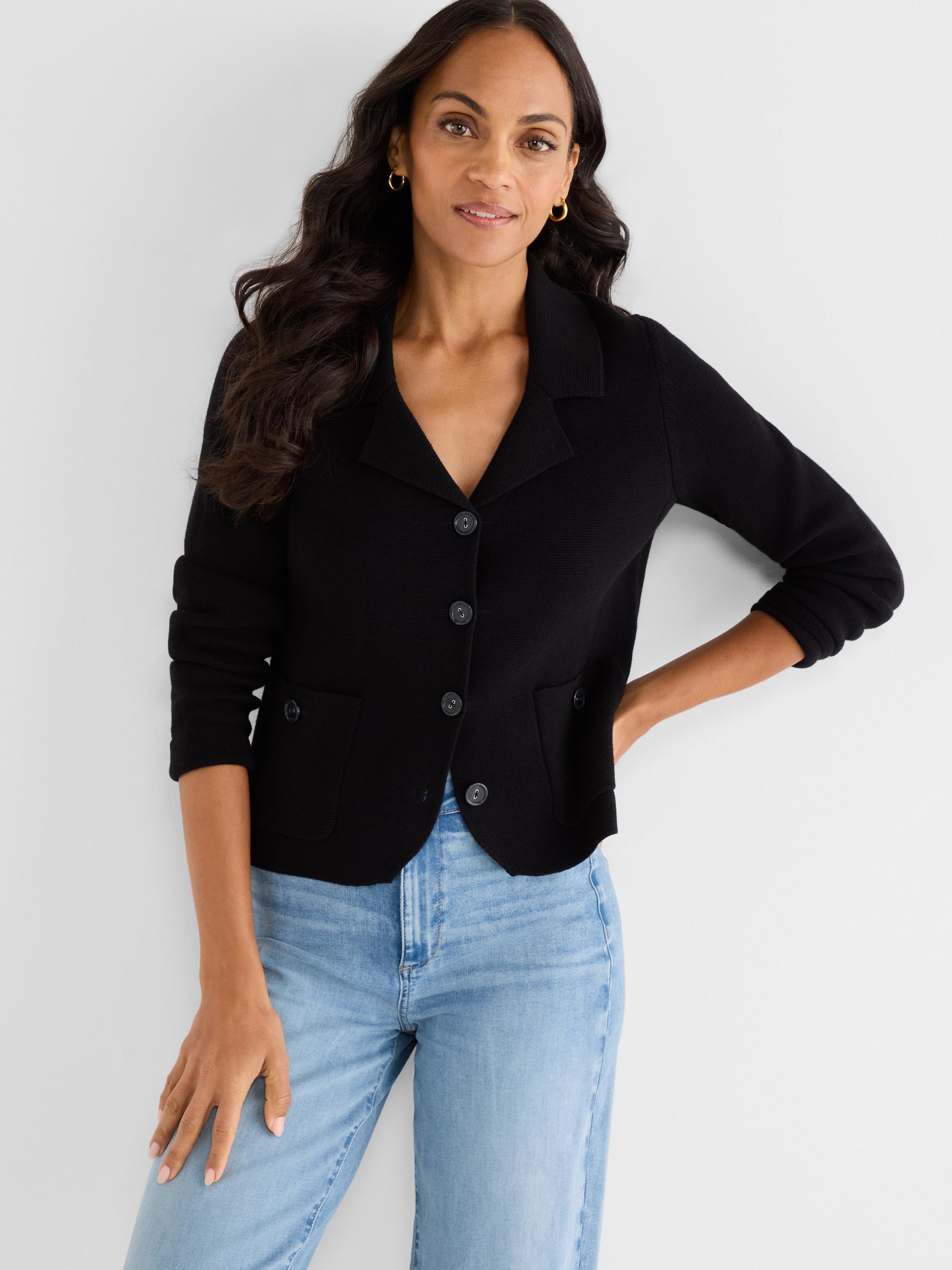 Fitted black knit jacket styled as a blazer featuring notch lapels, three front buttons, and waist patch pockets.