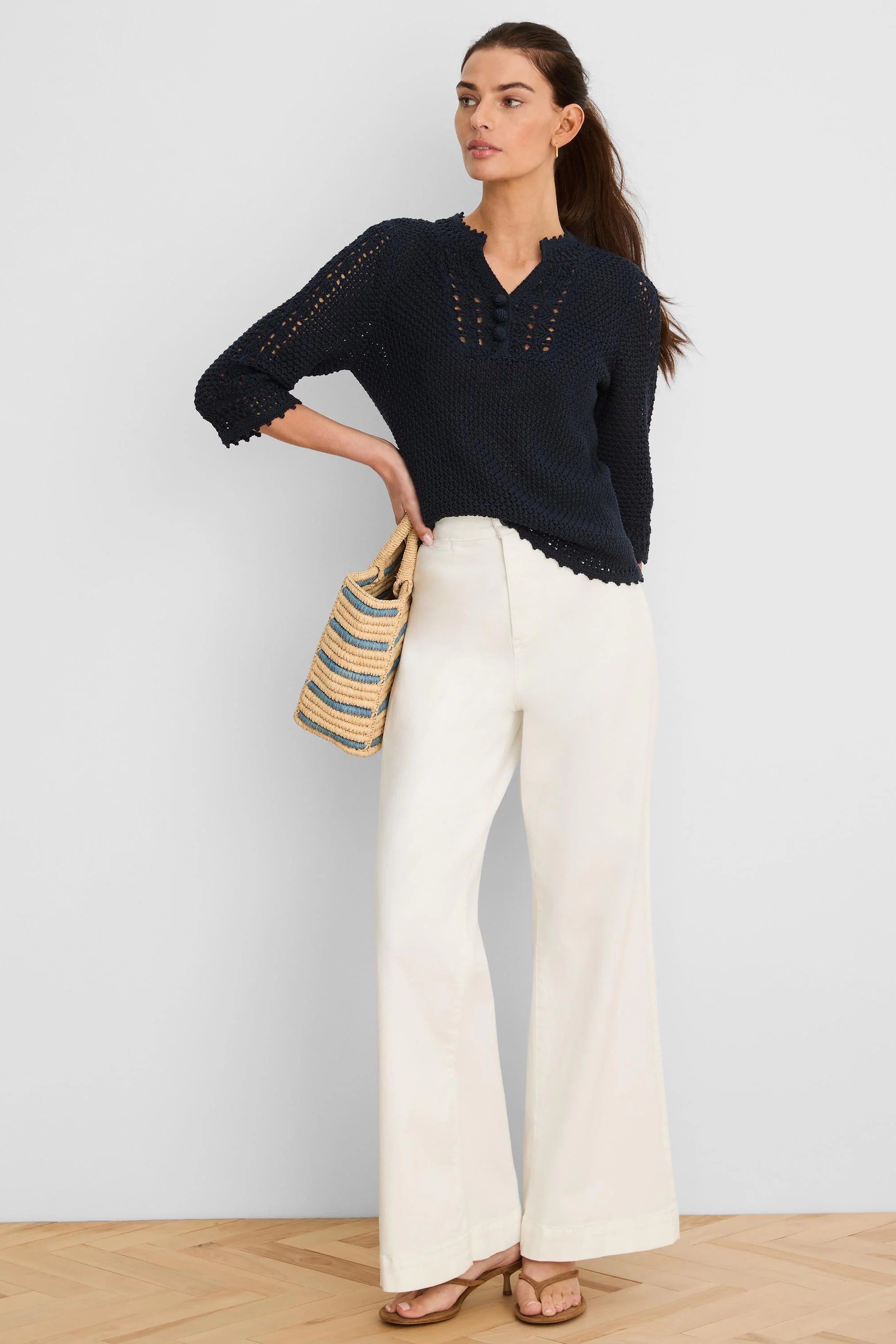 Dark blue V-neck sweater with open crochet mesh, 3 decorative buttons, and scalloped trim.