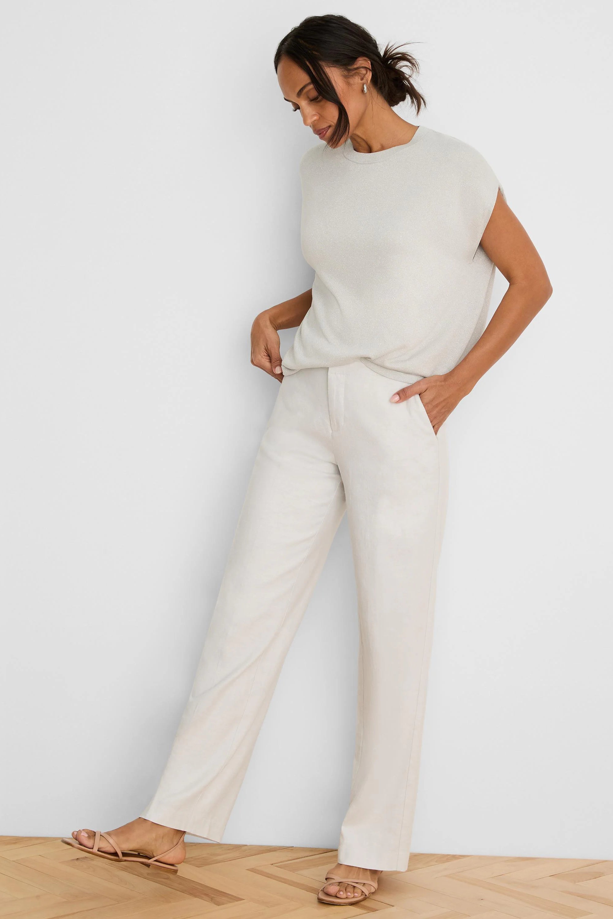 Light beige shimmering sleeveless cocoon sweater, round neck.