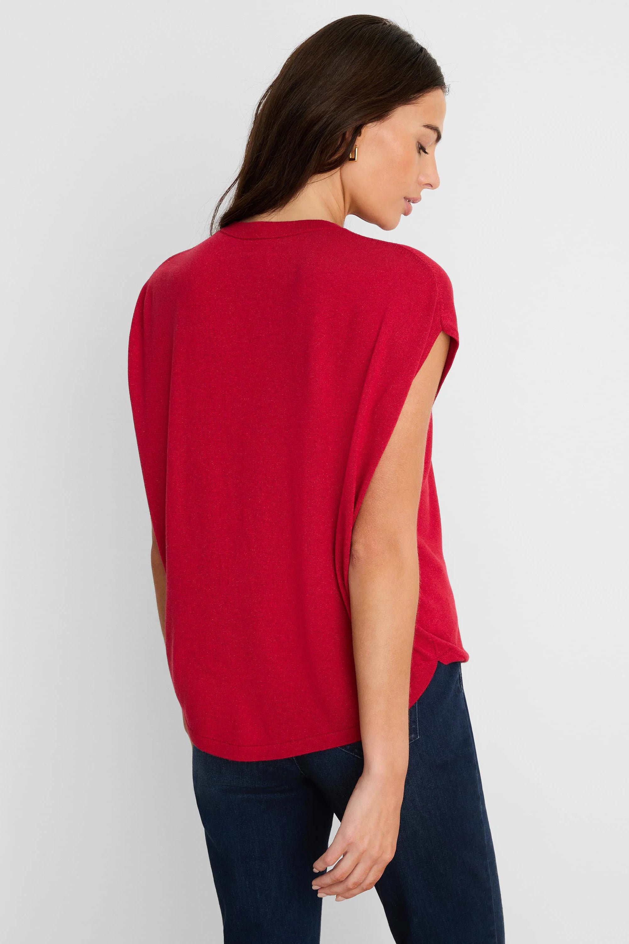 A red, fine-knit cocoon sweater with a loose fit and wide, open cap sleeves.