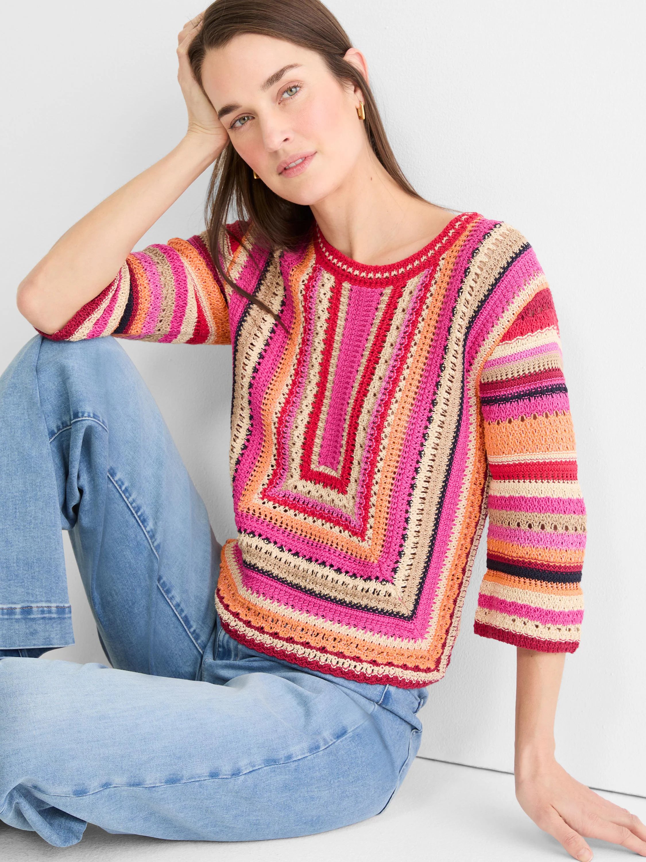Multi-color striped crochet sweater with a central square pattern and 3/4 sleeves. Features pink, orange, red, and tan hues.