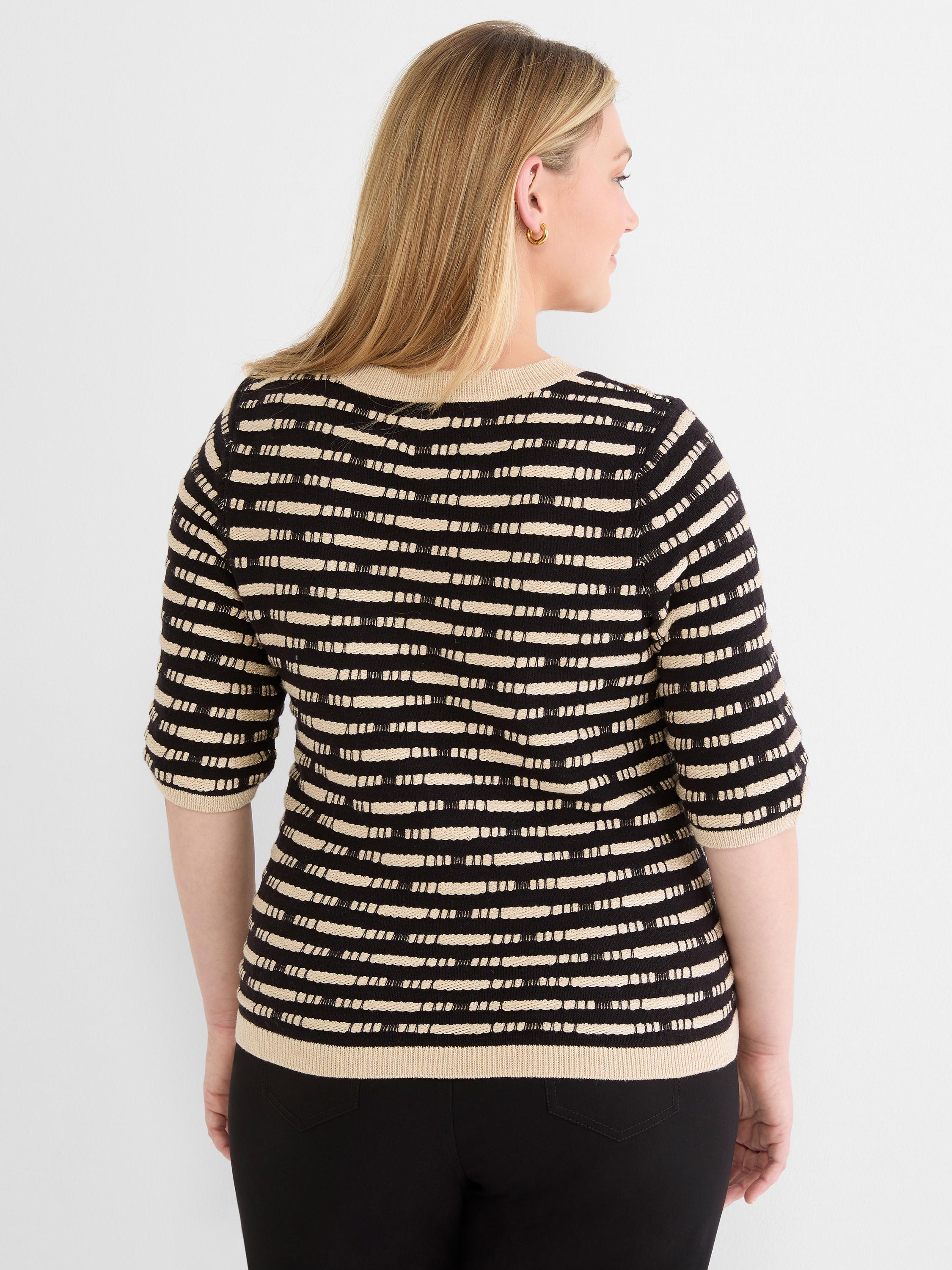 Fitted knit sweater in black and beige horizontal stripes with a textured stitch pattern and elbow-length sleeves.