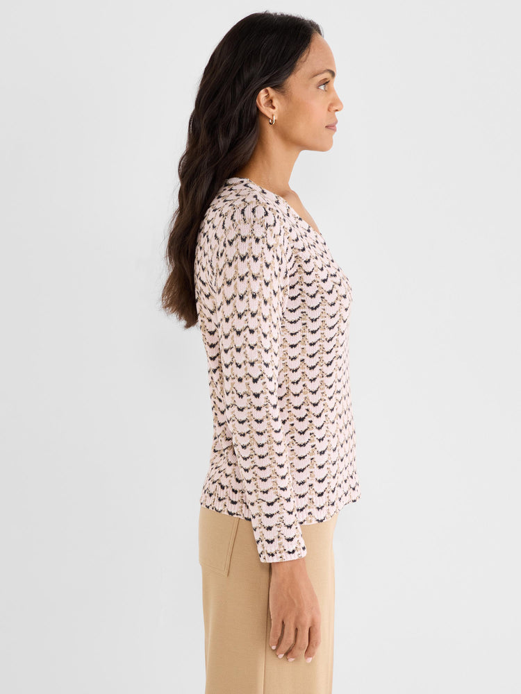 Fitted long-sleeve sweater in a pink, tan, and black chevron jacquard knit features a scoop neckline.